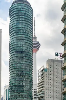 a tall glass building with a view of the space needle at KLCC Homestay Vacation Sky Suites KLCC Birdy Stay in Kuala Lumpur