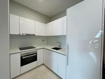 a white kitchen with white cabinets and a sink at KLCC Homestay Vacation Sky Suites KLCC Birdy Stay in Kuala Lumpur