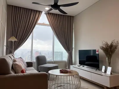 a living room with a ceiling fan and a large window at KLCC Homestay Vacation Sky Suites KLCC Birdy Stay in Kuala Lumpur