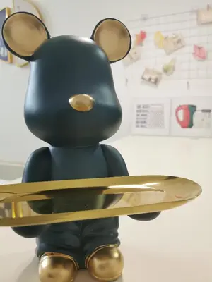 a toy animal holding a pair of scissors at Aishiteru Homestay in Kuala Lumpur