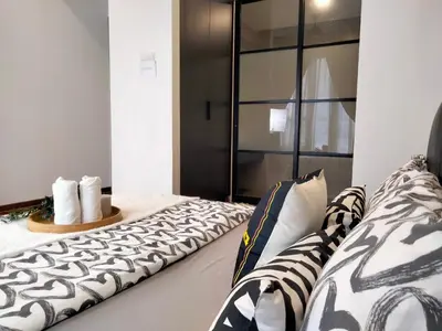 a bedroom with a bed with a large window at KL Gateway Premium Residence I HomeBrickz in Kuala Lumpur