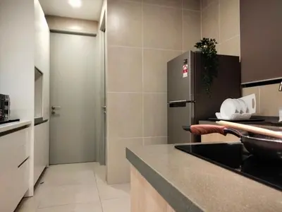 a kitchen with a refrigerator and a counter top at KL Gateway Premium Residence I HomeBrickz in Kuala Lumpur