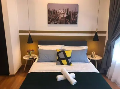 a bedroom with a large bed with two tables at KL Gateway Premium Residence I HomeBrickz in Kuala Lumpur