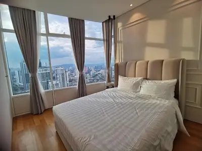 a bedroom with a bed with a large window at Sky Suites KLCC by Autumn Suites Premium Stay in Kuala Lumpur