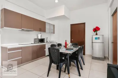 a kitchen and dining room with a table and chairs at Regalia Residence @ KLCC View Sky Pool by KC in Kuala Lumpur