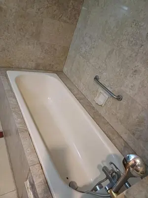 a white bath tub in a bathroom with a sink at Times Square Grand Service Suite in Kuala Lumpur