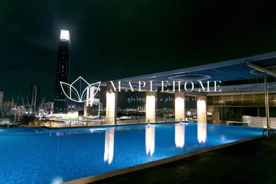 a large swimming pool in front of a building at night at D'Majestic Premier Suites Kuala Lumpur in Kuala Lumpur