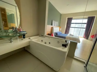 a bathroom with a large tub and a mirror at Stylish Romantic Couples Getaway at KL City 1419 in Kuala Lumpur