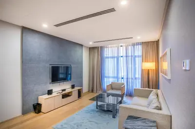 a living room with a couch and a tv at 188 Suites KLCC by CoBNB in Kuala Lumpur