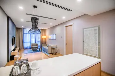 a kitchen and living room with a white counter top at 188 Suites KLCC by CoBNB in Kuala Lumpur