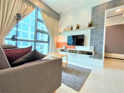 a living room with a couch and a tv at Infini Suites@ The Robertson Bukit Bintang in Kuala Lumpur