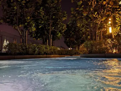 a swimming pool at night with trees and lights at Infini Suites@ The Robertson Bukit Bintang in Kuala Lumpur