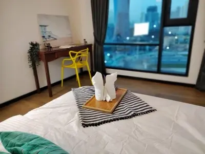 a hotel room with a bed with a desk and a window at OPUS RESIDENCE KL I HomeBrickz in Kuala Lumpur