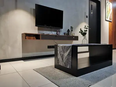 a living room with a flat screen tv on a wall at OPUS RESIDENCE KL I HomeBrickz in Kuala Lumpur
