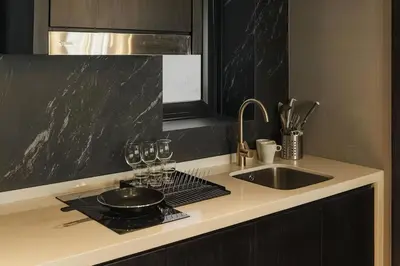 a kitchen counter with a sink and wine glasses at Agile Delima Residence Bukit Bintang in Kuala Lumpur