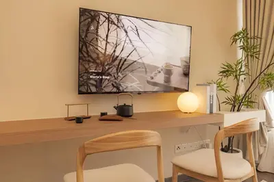 a desk with a television on a wall at Agile Delima Residence Bukit Bintang in Kuala Lumpur