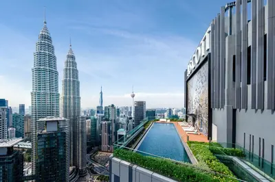 a view of a city from a building with a pool at Ascott Star KLCC Kuala Lumpur in Kuala Lumpur