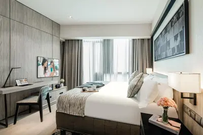 a hotel room with a bed and a desk at Ascott Star KLCC Kuala Lumpur in Kuala Lumpur