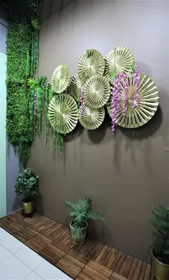 a wall with four paper umbrellas on it at Orkid Hills Hotel at Bukit Bintang in Kuala Lumpur