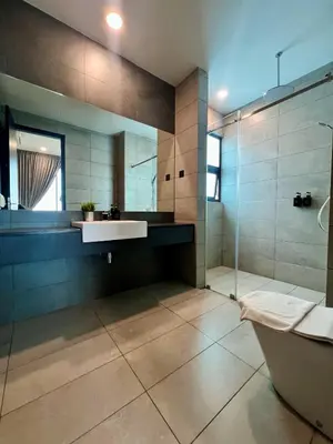 a bathroom with a tub and a sink and a shower at Opus Residence KL by EUcation Home in Kuala Lumpur