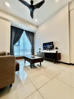 a living room with a table and a tv at Opus Residence KL by EUcation Home in Kuala Lumpur