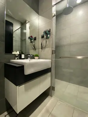 a bathroom with a white sink and a mirror at Opus Residence KL by EUcation Home in Kuala Lumpur