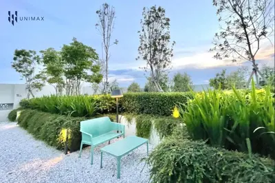 a garden with a blue chair and a table at UNA Sunway Velocity Kuala Lumpur by Unimax in Kuala Lumpur