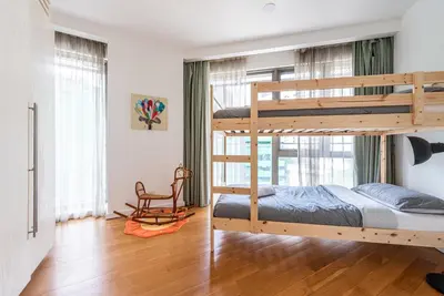a bedroom with two bunk beds and a chair at FAIRLANE 2mins walk to Bukit Bintang BEST SUNSET view 2BR 8-1 WIFI 100mbps in Kuala Lumpur