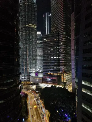 a view of a city at night with many tall buildings at GH KLCC Apartment by GuestHouse in Kuala Lumpur