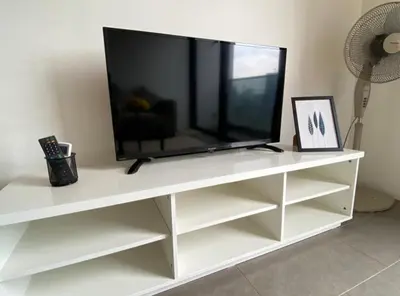 a flat screen tv on a white entertainment center at KL Sentral Loft , EST Bangsar #2, LRT in Kuala Lumpur