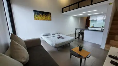 a living room with a couch and a table at KL Sentral Loft , EST Bangsar #2, LRT in Kuala Lumpur