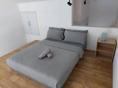 a bed with two pillows on it in a room at KL Sentral Loft, EST Bangsar #1, LRT in Kuala Lumpur