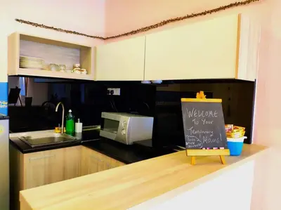 a kitchen with a microwave and a sign on a counter at Eco One Bedroom Apartment @ Jalan Ampang, 3 pax in Kuala Lumpur