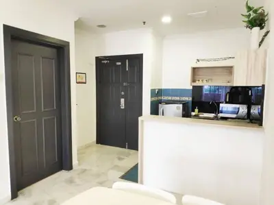 a kitchen with a black door and a counter at Eco One Bedroom Apartment @ Jalan Ampang, 3 pax in Kuala Lumpur