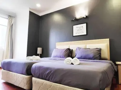 a bedroom with two beds with towels on them at Eco One Bedroom Apartment @ Jalan Ampang, 3 pax in Kuala Lumpur