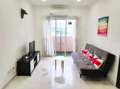a living room with a couch and a tv at Eco One Bedroom Apartment @ Jalan Ampang, 3 pax in Kuala Lumpur