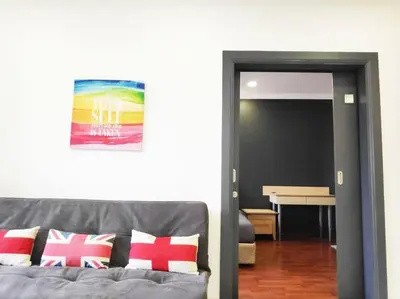 a living room with a gray couch with pillows at Eco One Bedroom Apartment @ Jalan Ampang, 3 pax in Kuala Lumpur