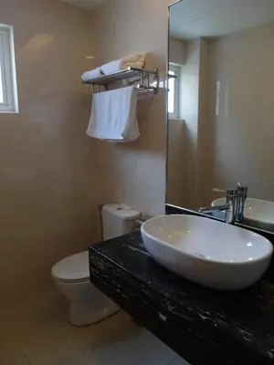 a bathroom with a sink and a toilet and a mirror at Metro Hotel @ KL Sentral in Kuala Lumpur