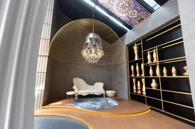 a room with a white chair and a chandelier at Near MITEC, Arte Mont Kiara by Cobnb in Kuala Lumpur