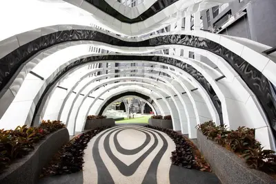 an archway in a building with plants at Near MITEC, Arte Mont Kiara by Cobnb in Kuala Lumpur