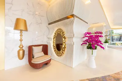 a room with a chair and a vase with flowers at Near MITEC, Arte Mont Kiara by Cobnb in Kuala Lumpur
