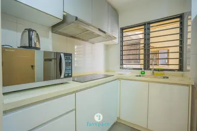 a kitchen with white cabinets and a microwave at Doorstep - Sunway Putra Mall - Close to PWTC for 4 in Kuala Lumpur