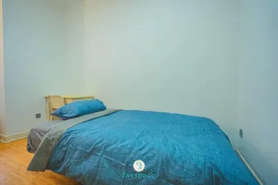 a bed with a blue comforter in a room at Doorstep - Sunway Putra Mall - Close to PWTC for 4 in Kuala Lumpur