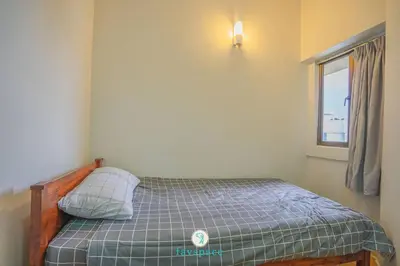 a small bed in a room with a window at Doorstep - Sunway Putra Mall - Close to PWTC for 4 in Kuala Lumpur