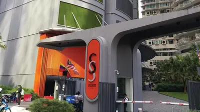 a building with a s sign on the side of it at Private Room at Sky Suites KLCC by iRent365 in Kuala Lumpur