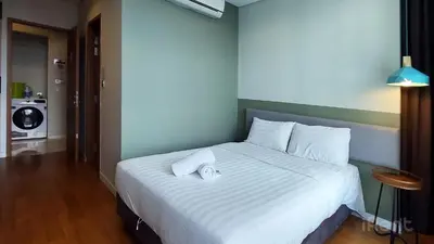 a bedroom with a large white bed in a room at Private Room at Sky Suites KLCC by iRent365 in Kuala Lumpur