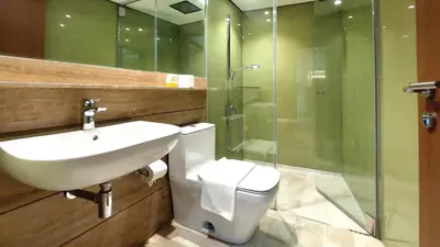 a bathroom with a sink and a toilet and a shower at Private Room at Sky Suites KLCC by iRent365 in Kuala Lumpur