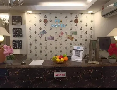 a reception desk in a hotel with a bowl of fruit at FKI INTERNATIONAL HOTEL in Kuala Lumpur