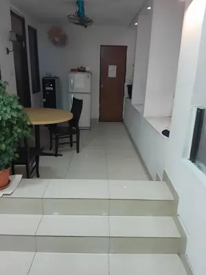 a staircase in a room with a table and chairs at FKI INTERNATIONAL HOTEL in Kuala Lumpur