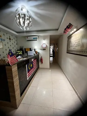 a restaurant with a counter with an american flag at FKI INTERNATIONAL HOTEL in Kuala Lumpur